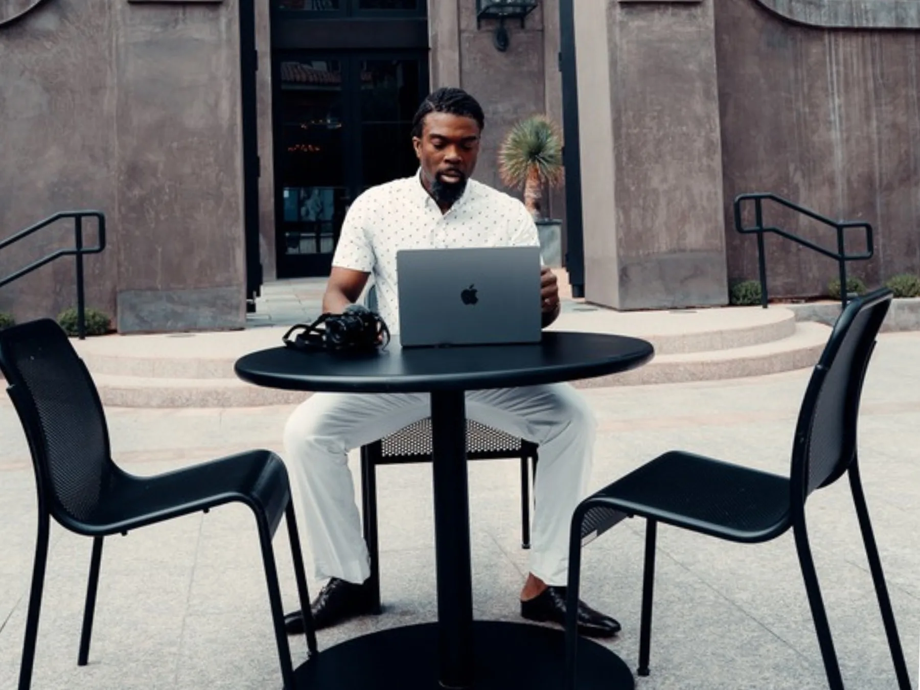 Dennison Blackett working at a laptop outdoors